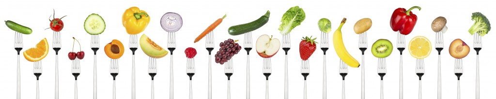 set of tasty fruits and vegetables on forks isolated on white background